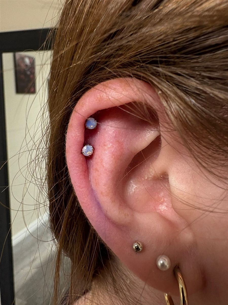 Double helix and stacked lobe piercings with jeweled studs