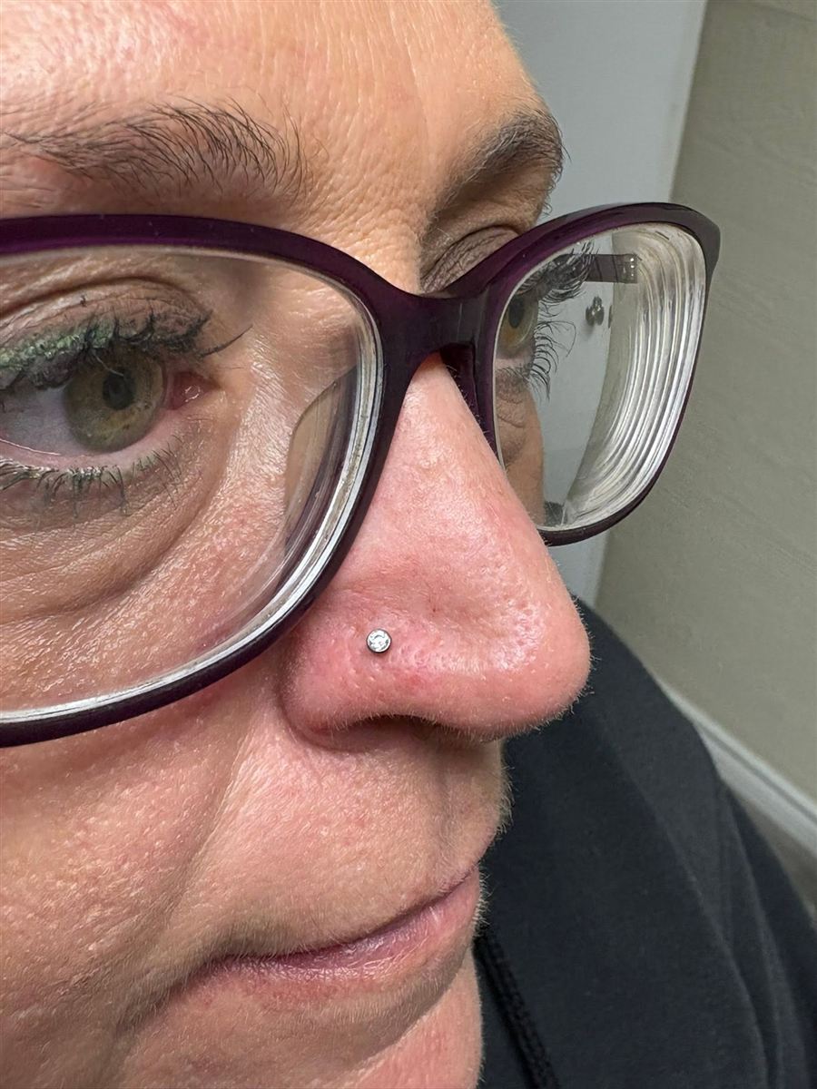 Nostril piercing with a jeweled stud