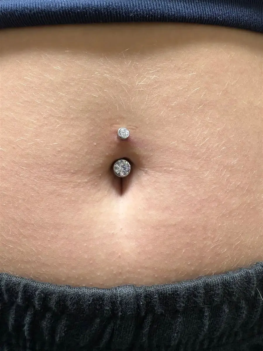 Fresh navel piercing with double jeweled barbell