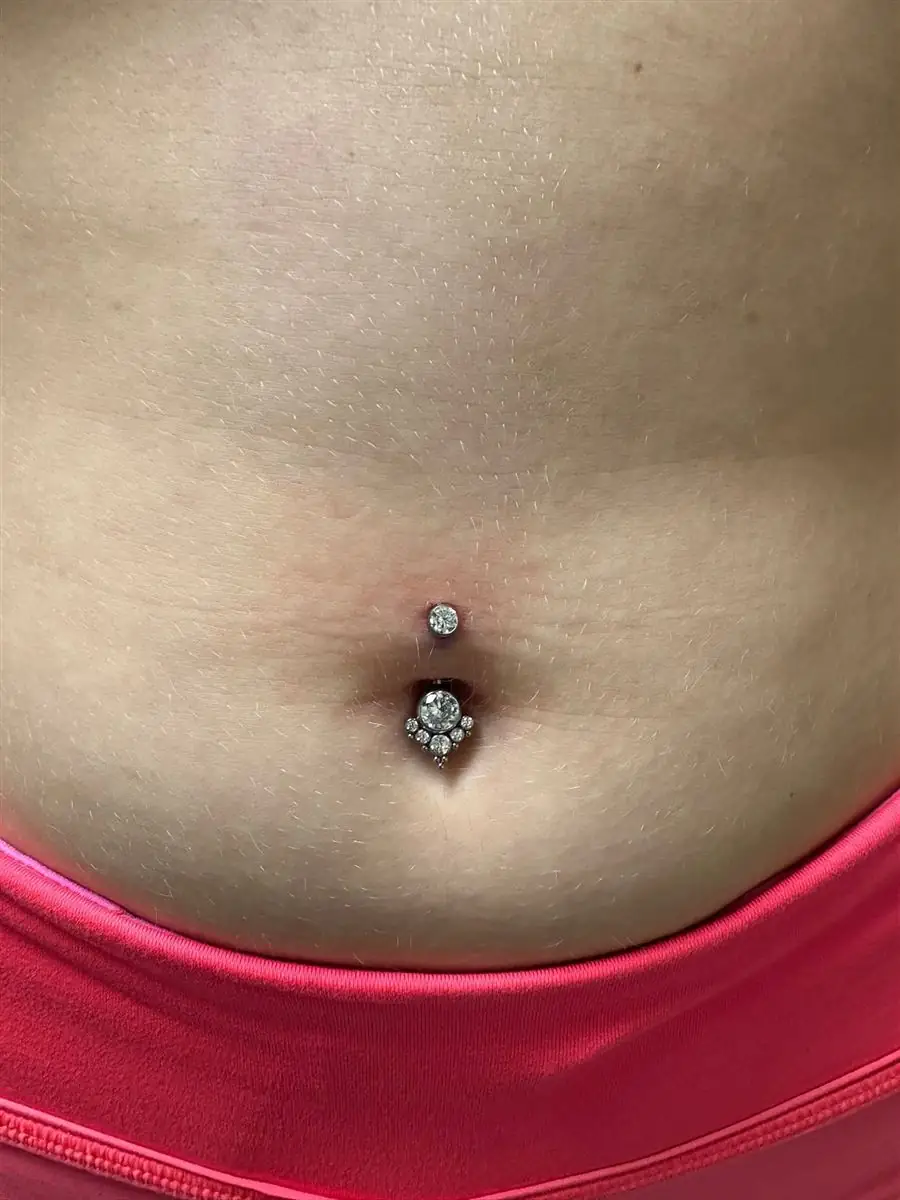 Navel piercing with jeweled implant-grade jewelry, pierced in Glen Rose TX