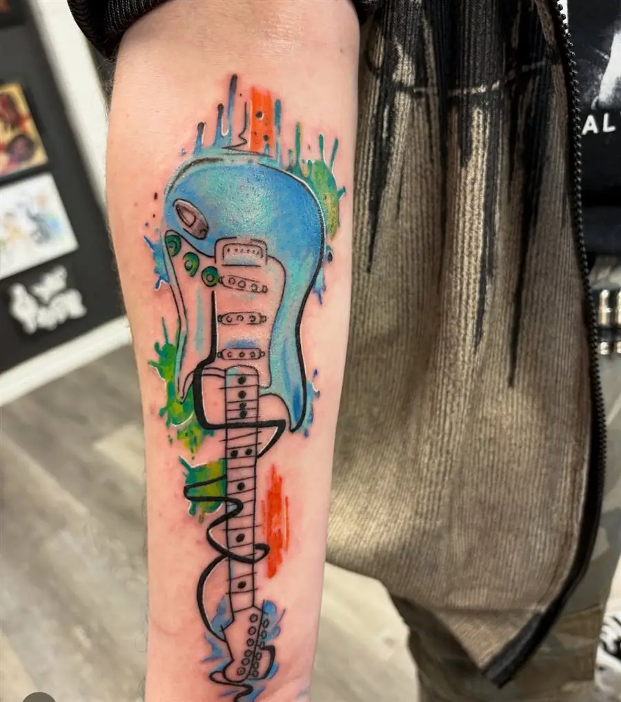 Watercolor electric guitar color tattoo on the forearm